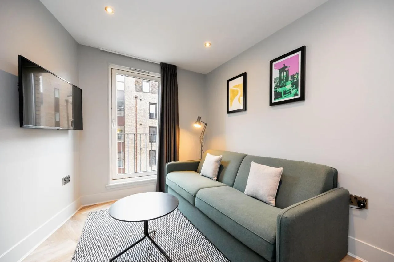 a living room with a couch and a window at Staycity Aparthotels Edinburgh West End in Edinburgh