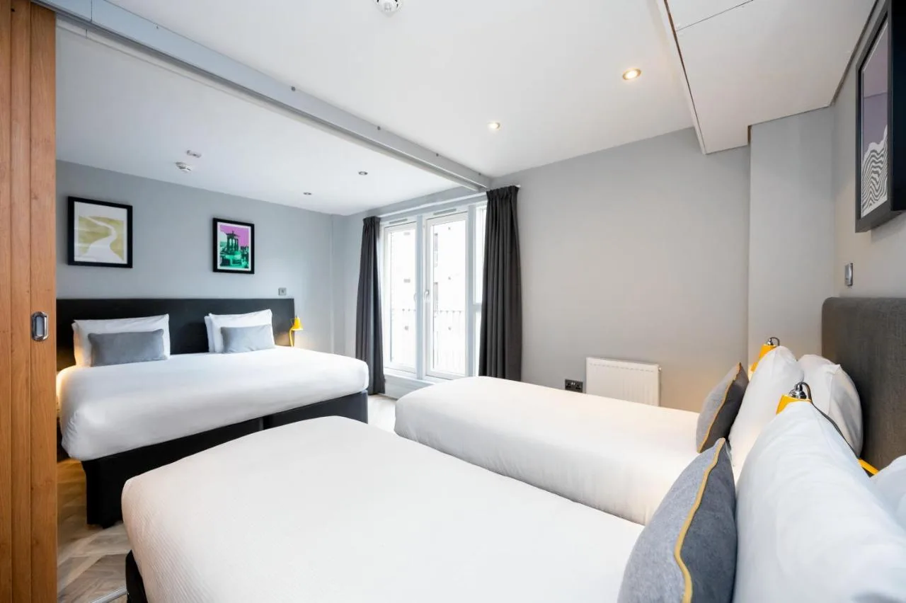 a hotel room with two beds and a window at Staycity Aparthotels Edinburgh West End in Edinburgh