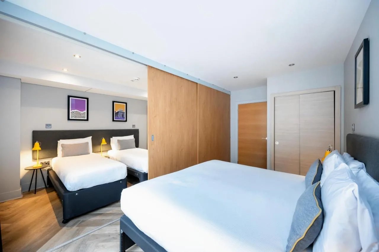 a hotel room with two beds and a bedskirts at Staycity Aparthotels Edinburgh West End in Edinburgh